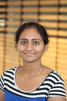 A person standing in front of a window posing for the camera

Description automatically generated